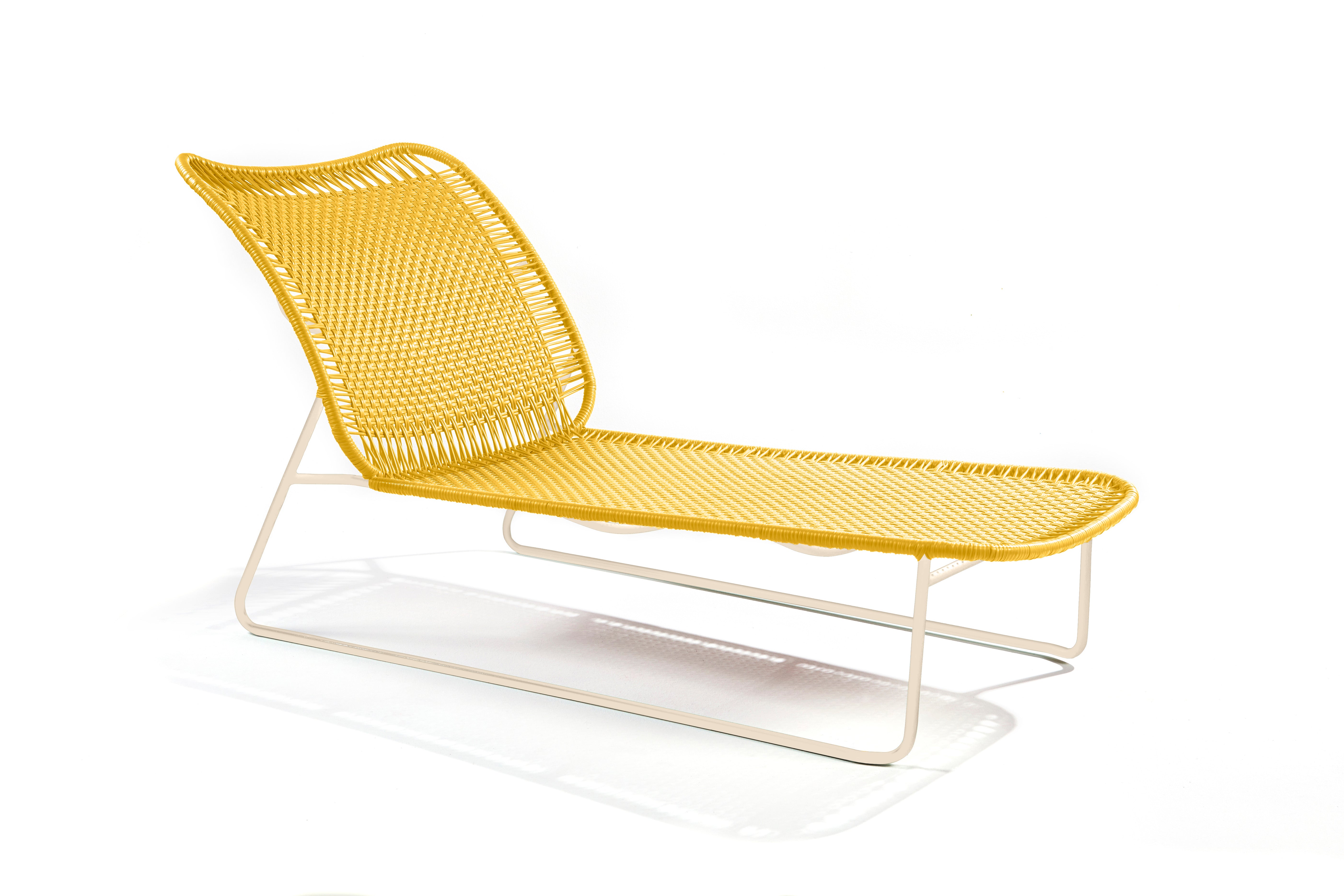 Ames Cielo Daybed by Ames: a modern yellow woven lounge chair with a white metal frame, inspired by Sebastian Herkner’s sleek lines, featuring a curved backrest and seat on a plain white background.