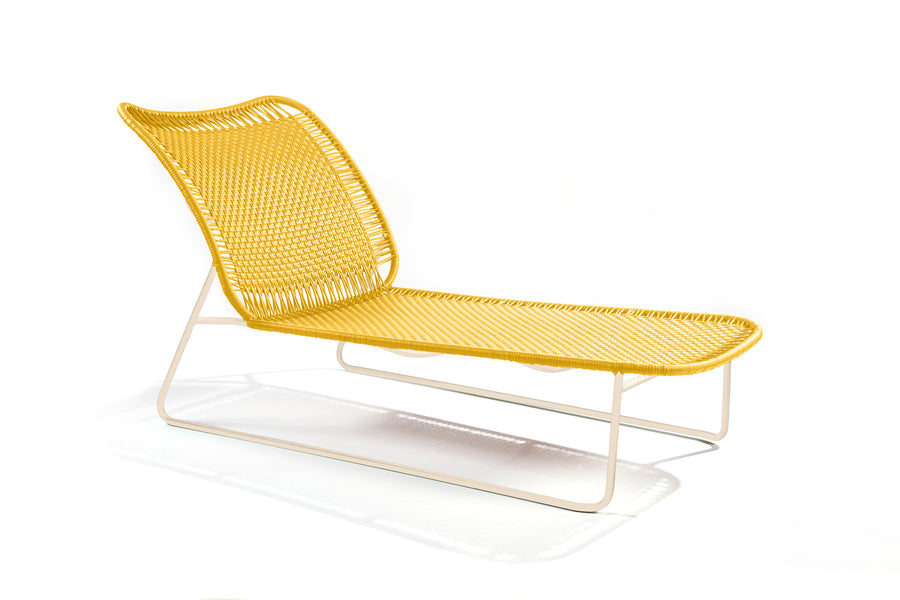 Ames Cielo Daybed by Ames: a modern yellow woven lounge chair with a white metal frame, inspired by Sebastian Herkner’s sleek lines, featuring a curved backrest and seat on a plain white background.