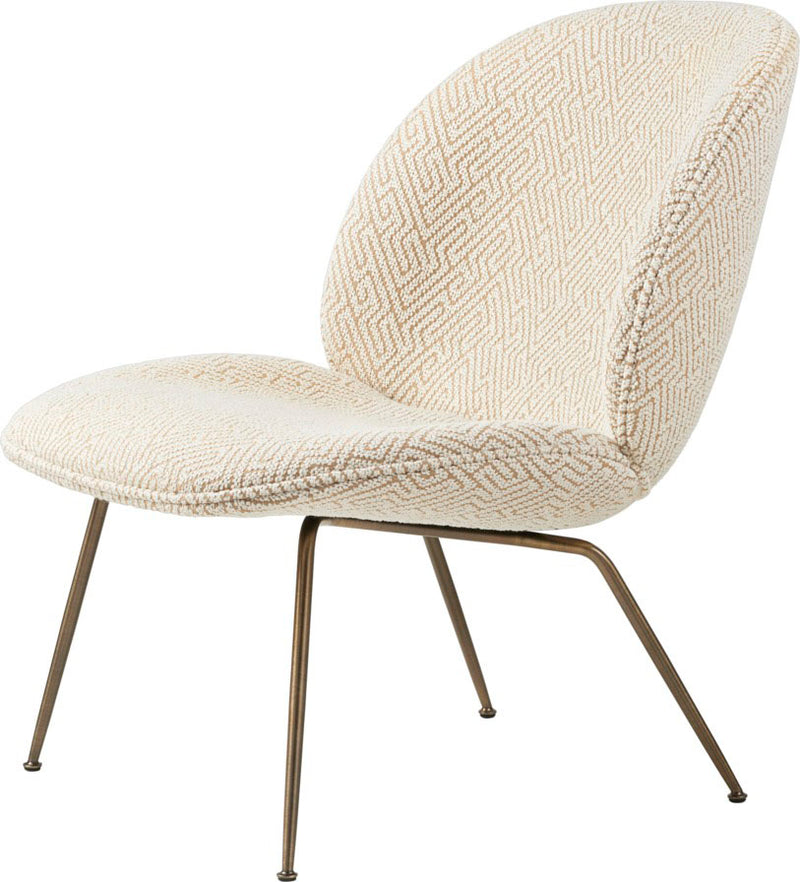 Lounge chair with textured cream fabric upholstery and angled slender bronze metal legs