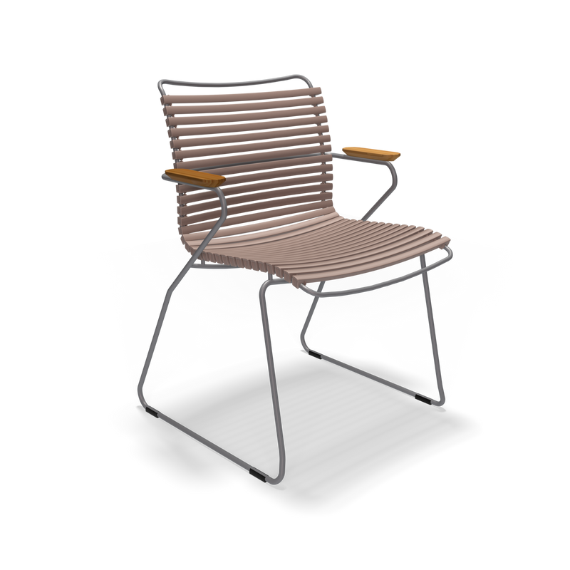 The Houe Click Dining Chair with Armrest, featuring a sturdy metal frame and slatted design in beige, boasts weather-resistant, UV-protected materials. It includes wooden accent armrests, is lightweight, has a contemporary style, and is showcased against a plain black background.