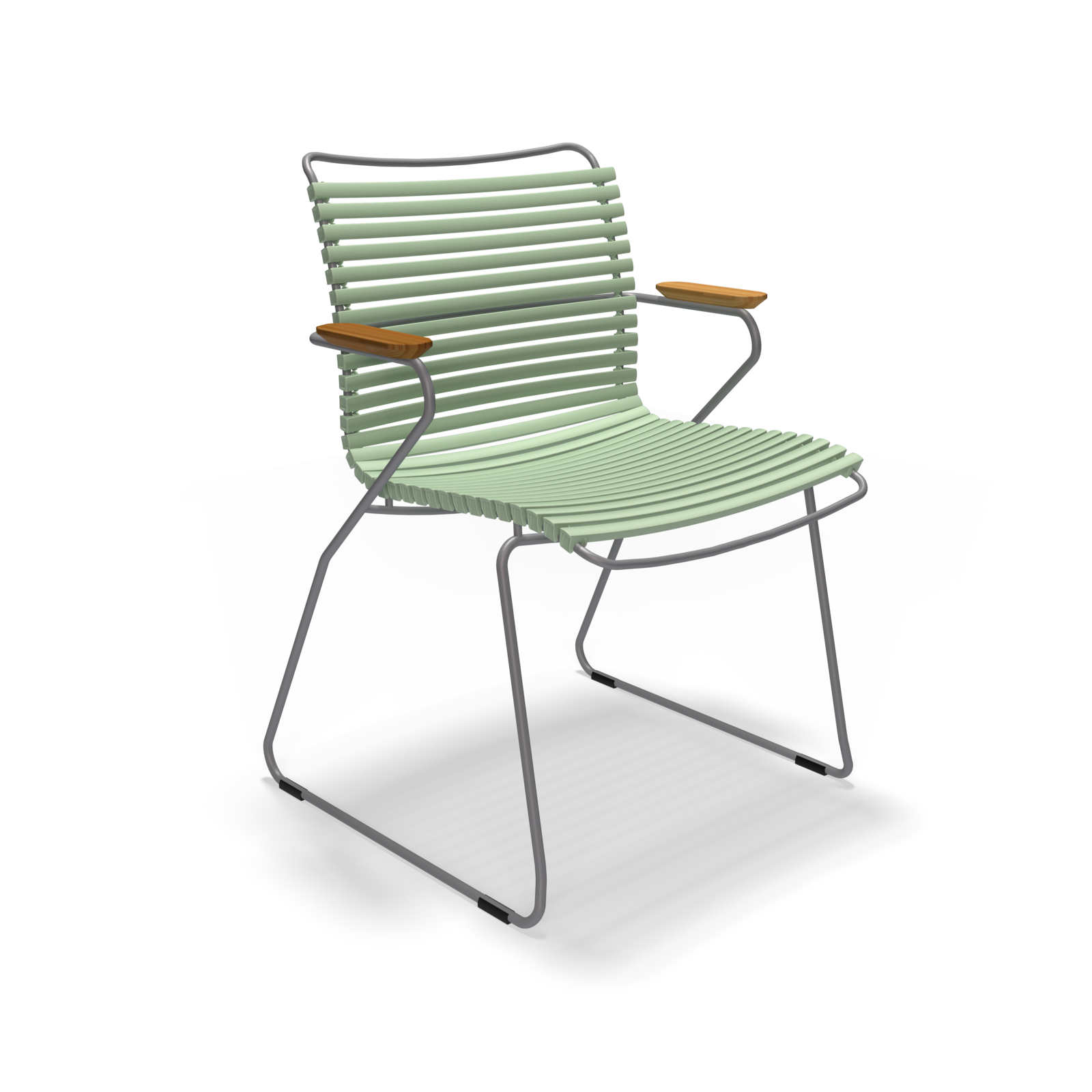 The Click Dining Chair with Armrest by Houe features modern green slatted plastic lamellas, a thin metal frame, curved wooden armrests, and sled-style legs. Its weather-resistant design is ideal for outdoor use and offers a minimalist look against a plain black background.