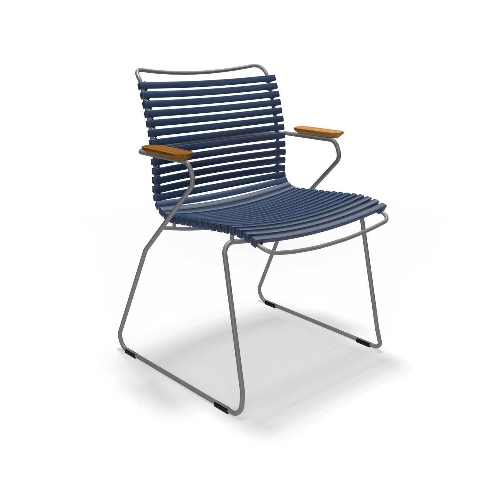 The Click Dining Chair with Armrest by Houe features a sleek design with weather-resistant, ribbed dark blue plastic lamellas for the seat and backrest, complemented by thin metal legs and wooden armrests. The minimalist and contemporary look is set against a plain black background.