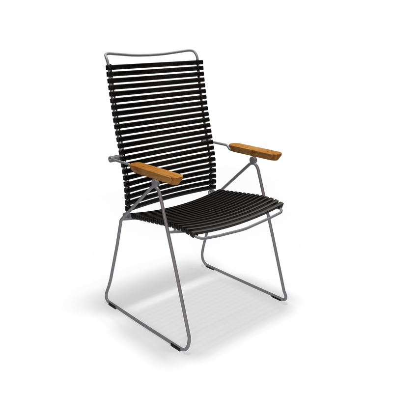 The Click Position Chair by Houe is a black outdoor chair with a sleek, minimalist design, weather-resistant horizontal slats, and a sturdy black metal frame. It features wooden armrests and a slightly reclined back for added comfort.