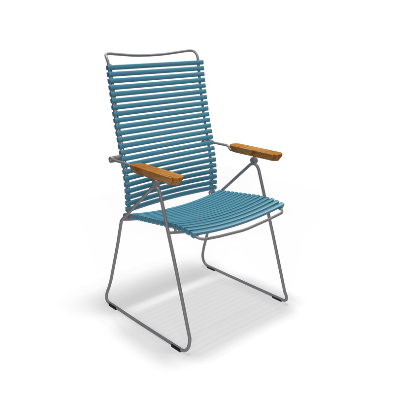 The Click Position Chair by Houe is set against a black background, featuring a blue rope design with a metal frame and wooden armrests. Its crafted for modern outdoor spaces using weather-resistant materials and showcases slat-style seating and backrest.