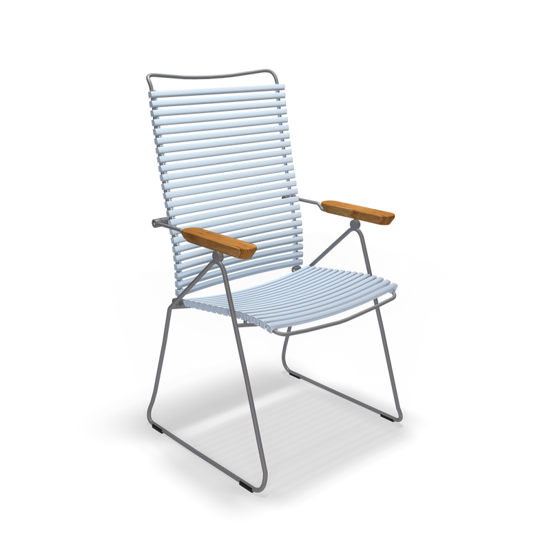 The Click Position Chair by Houe is a modern outdoor chair with a sleek metal frame, weather-resistant plastic lamellas for the backrest and seat, and wooden armrests, blending contemporary style with classic elements.