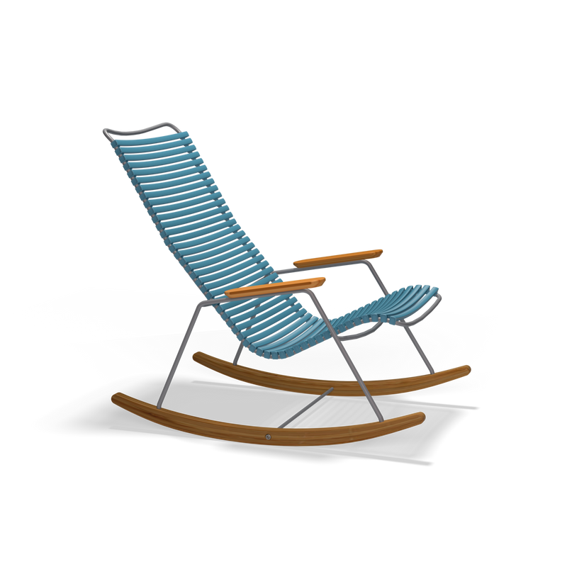 The Click Rocking Chair by Houe is a modern outdoor piece with weather-resistant blue plastic slats for the seat and backrest, supported by a metal frame with wooden armrests. Curved wooden rockers enhance its design against a solid black background.