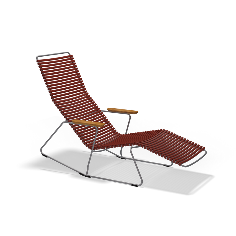 The Click Sunrocker by Houe features a sleek metal frame, reddish-brown woven ribbed seat and backrest, wooden armrests, and an extended footrest. This modern lounge chair is perfect as an outdoor chair and isolated on a black background.