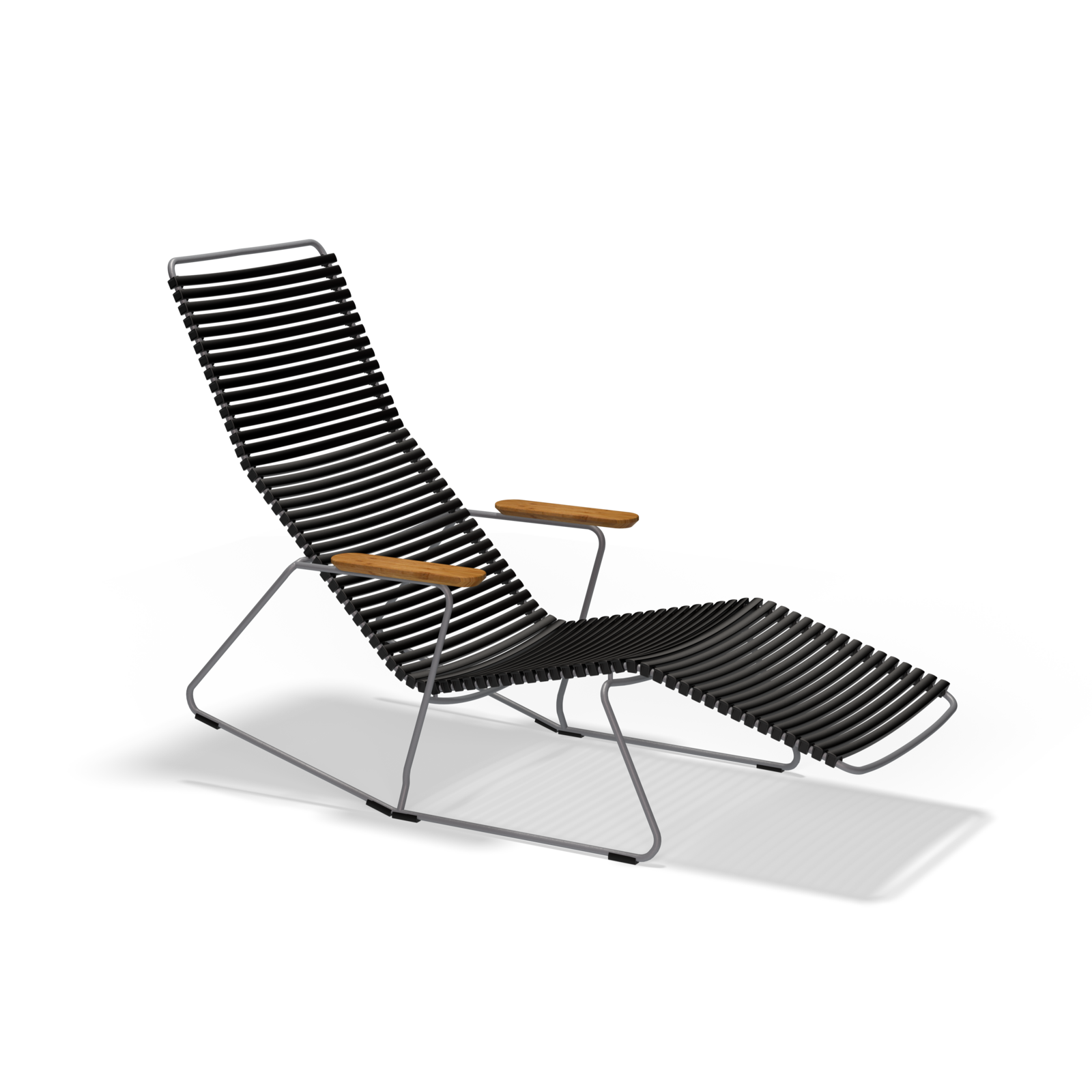 The Click Sunrocker by Houe is a sleek black lounge chair with a ribbed design and wooden armrests, featuring an inclined backrest and footrest. It combines metal with stylish bamboo elements for an elegant touch, beautifully set against a black background.