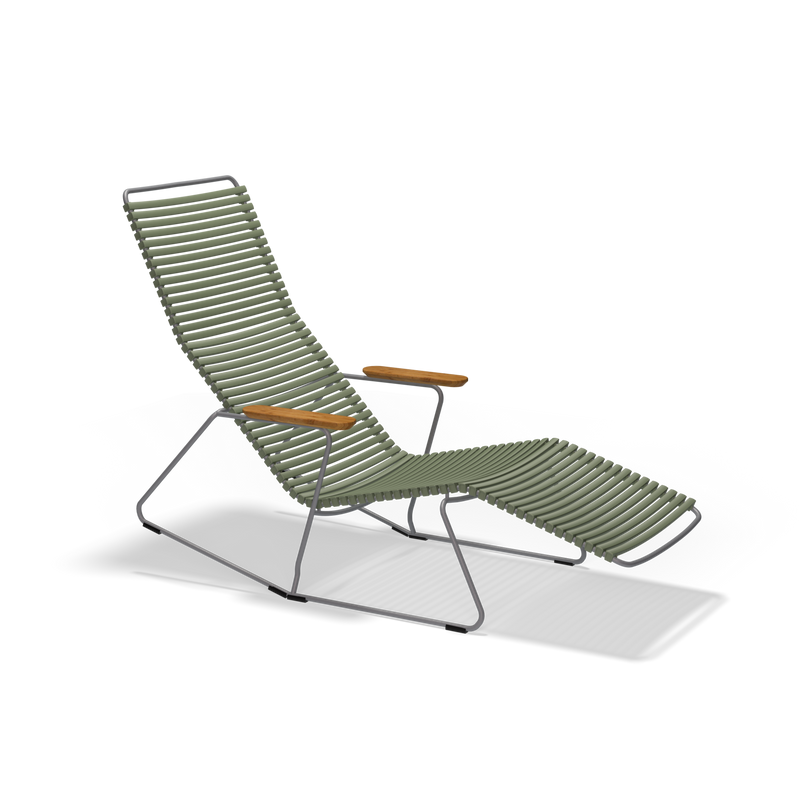 The Houe Click Sunrocker is a modern outdoor lounge chair featuring a green slatted design and wooden armrests, supported by a slender powder-coated steel frame. It includes an extended leg rest for a sleek, minimalistic look against the black background.