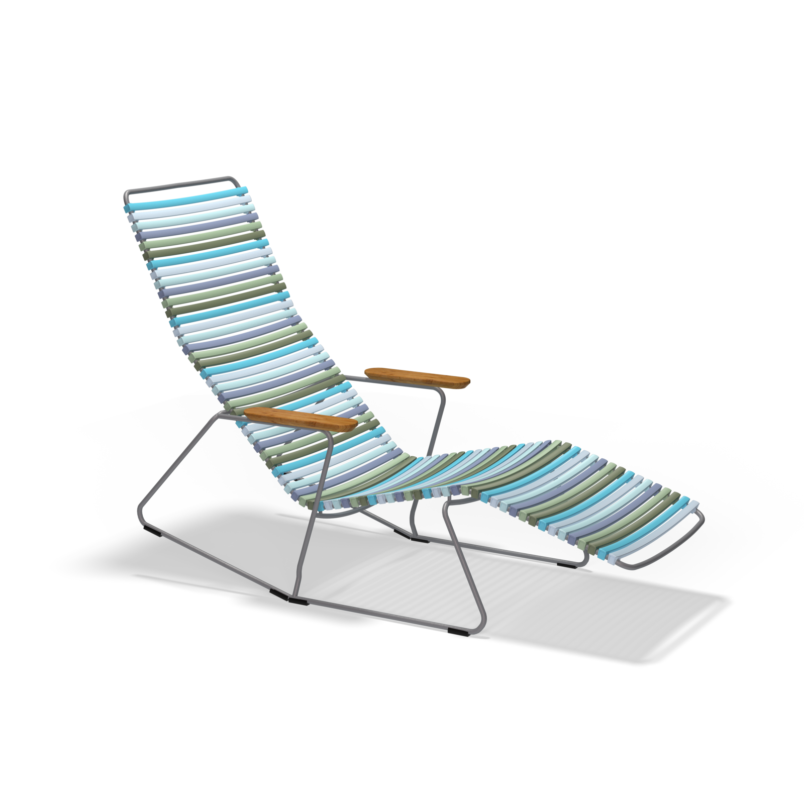 The Houe Click Sunrocker is a modern outdoor lounge chair with an angled metal frame, featuring blue, green, and gray horizontal slats. It includes wooden armrests and a bamboo-infused extended leg rest for added relaxation and natural charm.