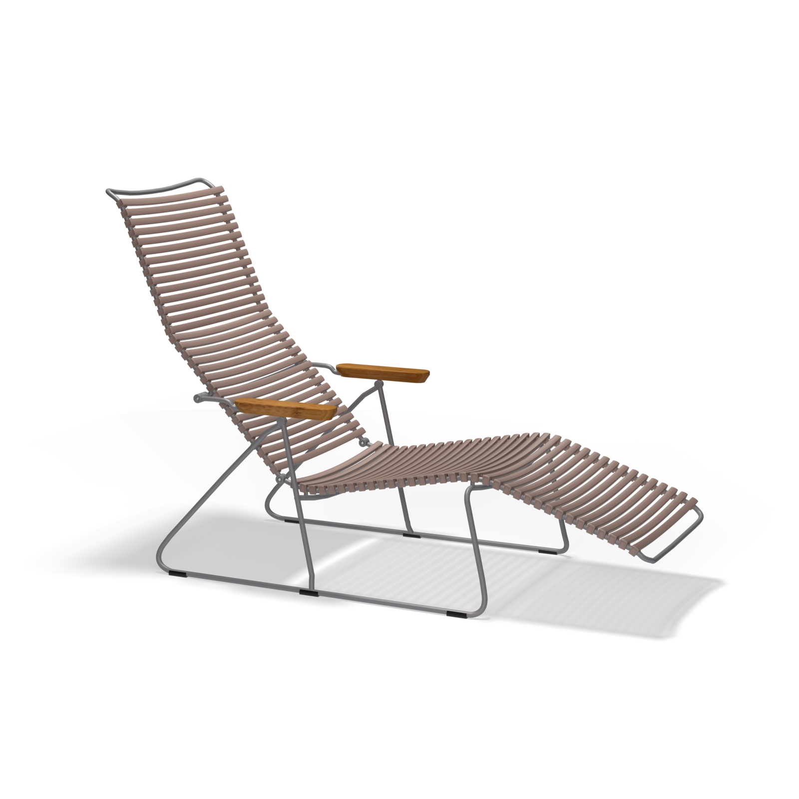 The Click Sunlounger by Houe features a minimalist tubular metal frame with brown woven rope for the seat and backrest, wooden armrests, and a leg extension. Perfect for outdoor seating, this modern chair stands stylishly against a sleek black background.