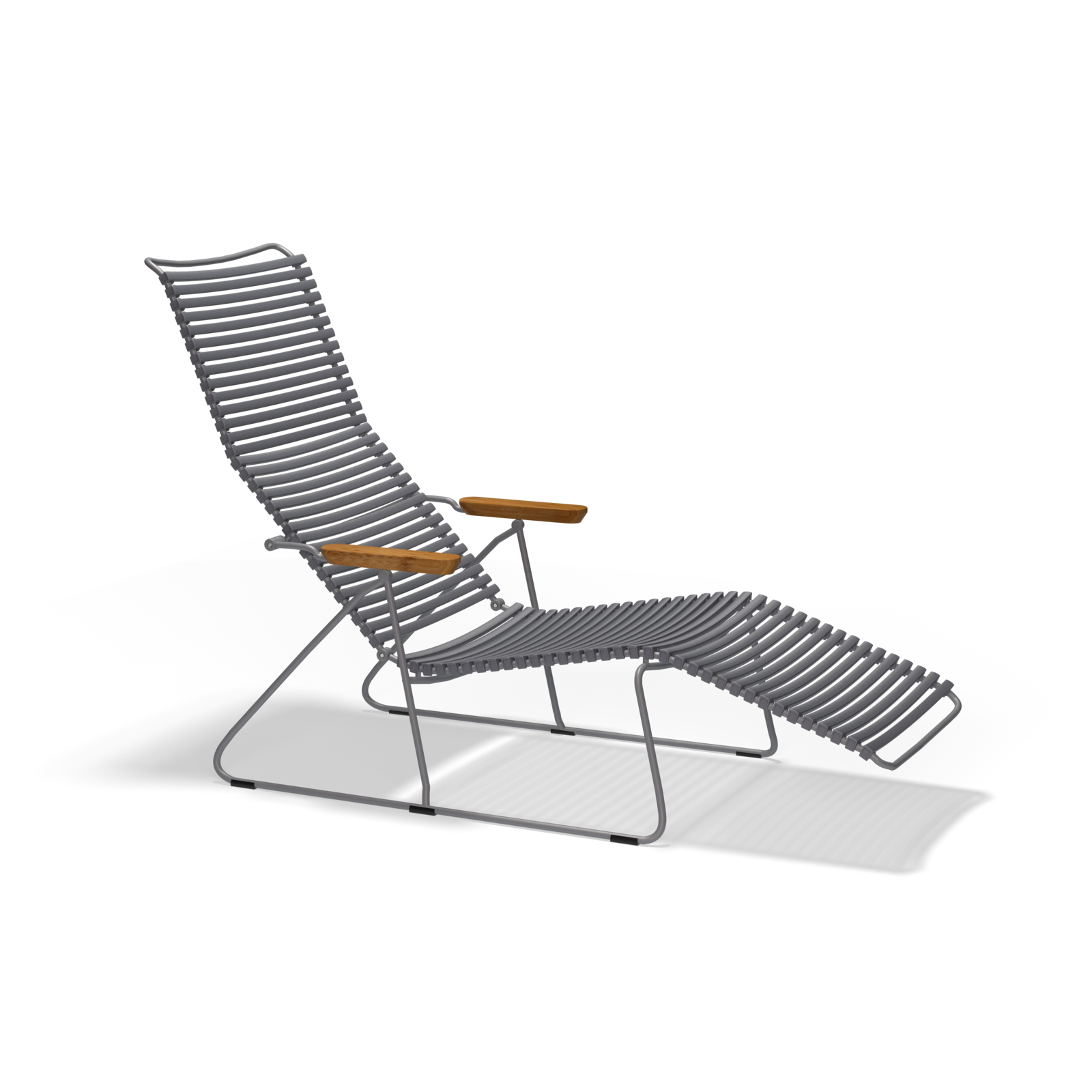 The Houe Click Sunlounger is a modern outdoor lounge chair featuring a sleek metal frame and horizontal slats for the seat and backrest, complemented by light wood armrests. This UV-protected, cushion-free seating stands stylishly against a black background.