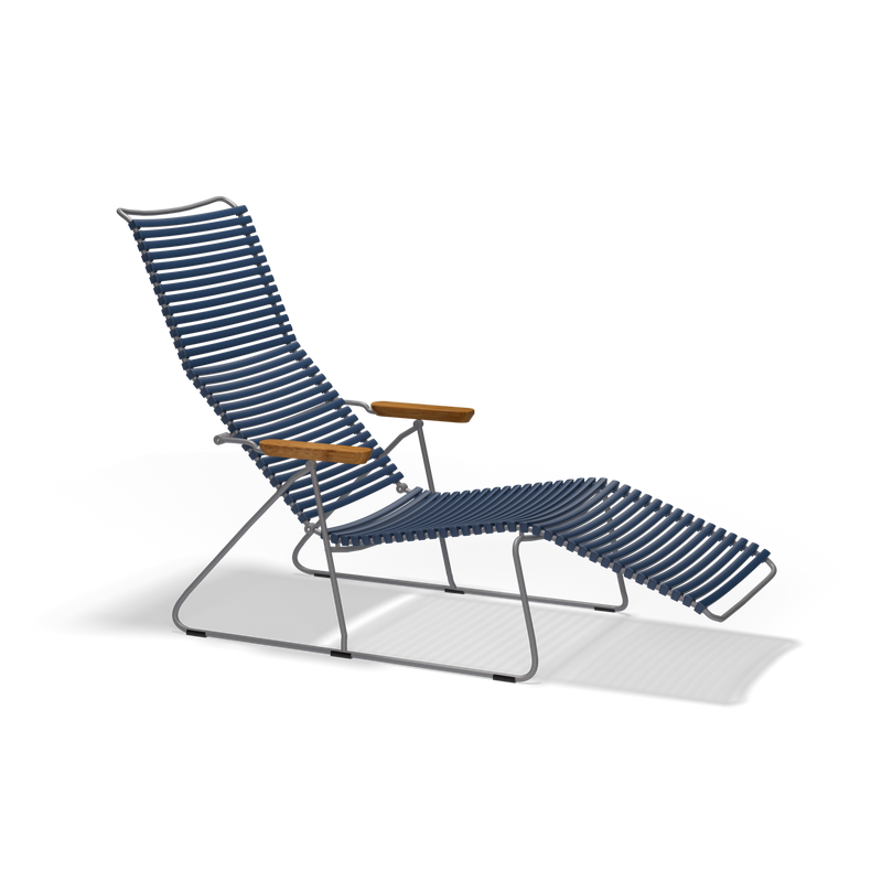 The Click Sunlounger by Houe boasts a sleek metal frame and cushion-free design, featuring UV-protected blue cords for the seat and back. It has a high backrest, integrated footrest, and warm wooden armrests. Its elegant look against a black background makes it perfect for outdoor relaxation.