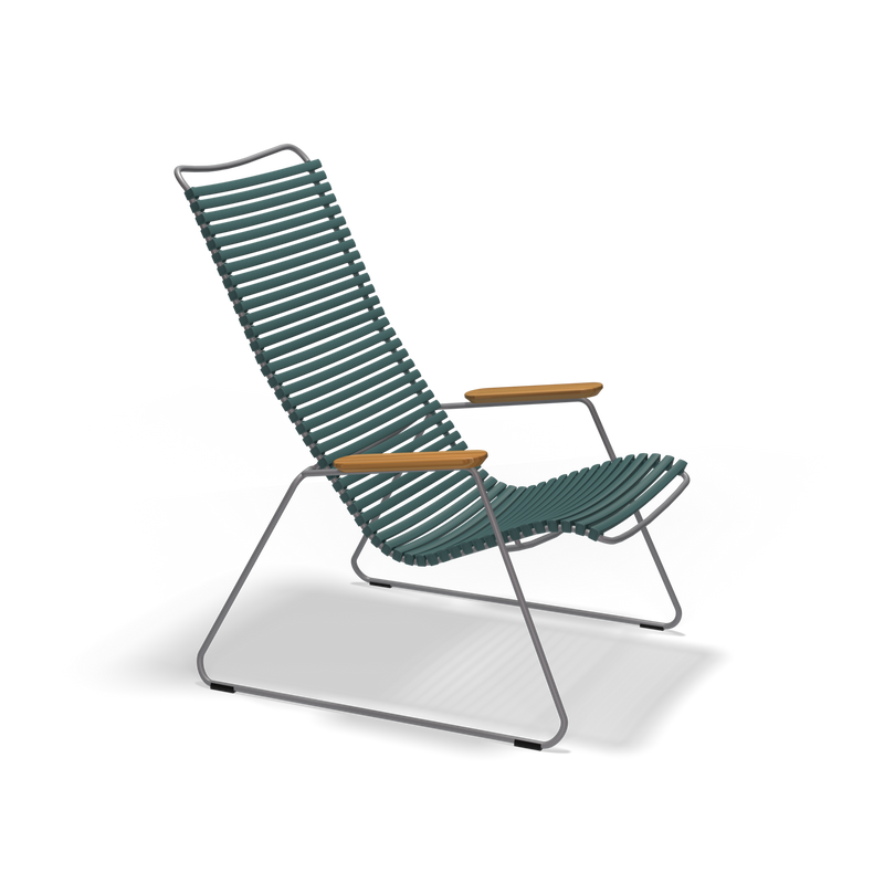 The Click Lounge Chair by Houe boasts a teal high slatted backrest and seat with durable plastic lamellas, metal legs, and wooden armrests. Its sleek, minimalist design makes it perfect for contemporary spaces.