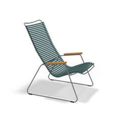 The Click Lounge Chair by Houe boasts a teal high slatted backrest and seat with durable plastic lamellas, metal legs, and wooden armrests. Its sleek, minimalist design makes it perfect for contemporary spaces.
