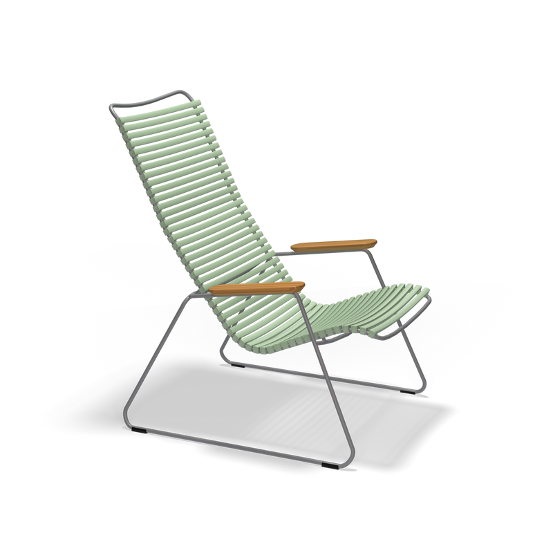The Click Lounge Chair by Houe is a modern outdoor piece with a sleek design. It features a high backrest and seat made of horizontal green bamboo slats, a minimalist black metal frame, weather-resistant qualities, wooden armrests, angled legs, and offers contemporary style.