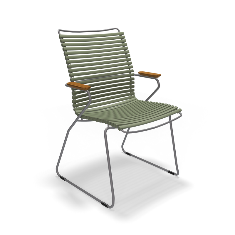 The Click Dining Chair with Armrest - Tall Back by Houe features a contemporary olive green design, horizontal rope on a sleek metal frame, and curved armrests with wooden accents. Ideal for outdoor use, its weather-resistant and UV-protected for durability.