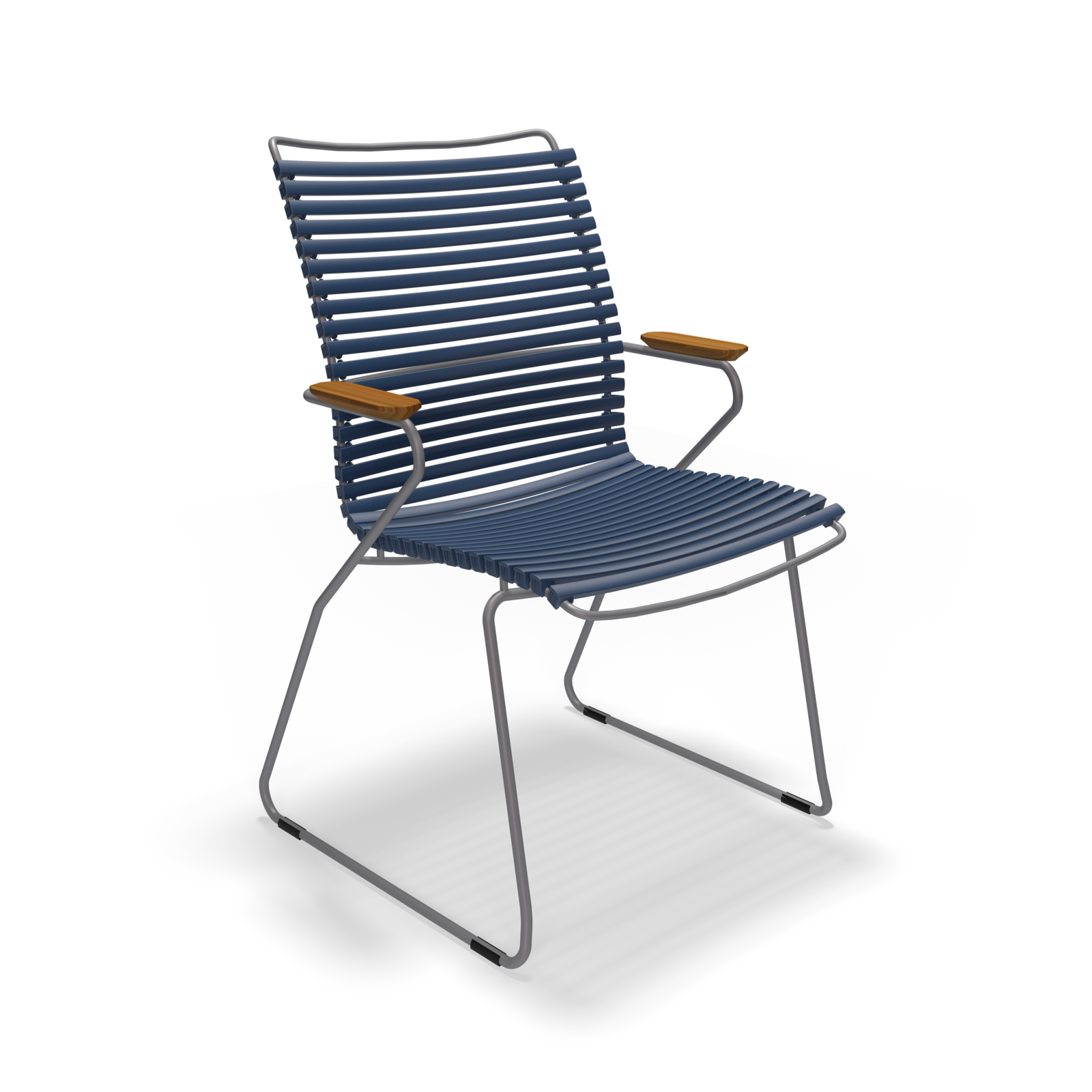 The Click Dining Chair with Armrest by Houe is a modern outdoor chair featuring a blue slatted back and seat, weather-resistant metal sled base legs, and wooden armrests, ensuring durability against the elements.