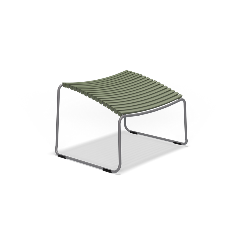 The Houe Click Footrest is a minimalist, modern stool featuring a curved seat of green plastic lamellas on a sleek metal frame. Its UV-protected design merges function and aesthetics, making it ideal for both indoor and outdoor use. The footrest’s black frame stands against a plain white backdrop.