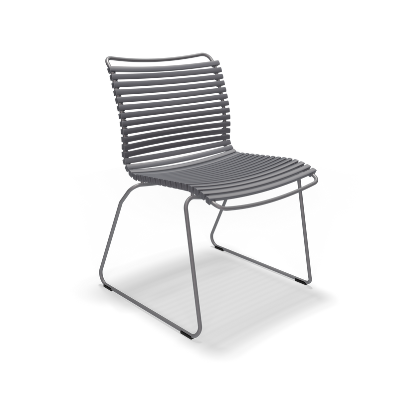 The Click Dining Chair without Armrest by Houe features a modern, minimalist wireframe design in grey. Built for outdoor use, it has weather-resistant parallel metal slats on the seat and back, complemented by a sled-style base. Its sleek look stands out against a solid black background.