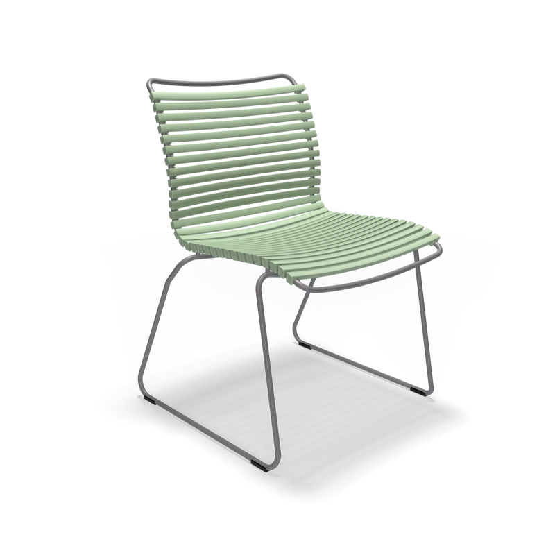 The Click Dining Chair without Armrest by Houe is a modern outdoor chair with a minimalist design, featuring weather-resistant, light green plastic lamellas for the seat and backrest, complemented by thin metal legs and set against a black background.