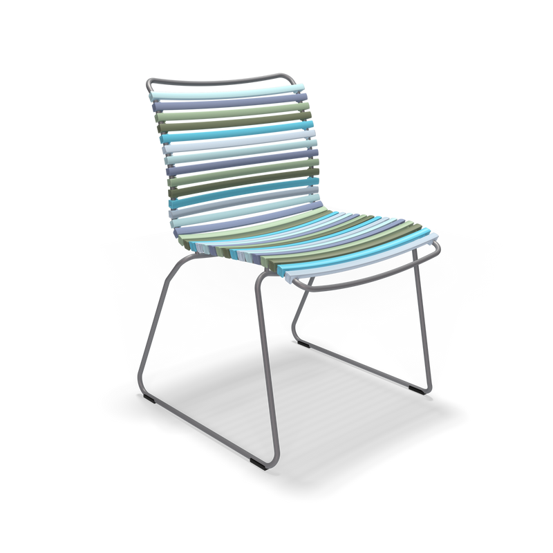 The Click Dining Chair without Armrest by Houe features a contemporary design with weather-resistant metal legs and a seat of horizontal, multicolored plastic lamellas in teal, green, and blue tones. Its sleek appearance contrasts elegantly against a black background.