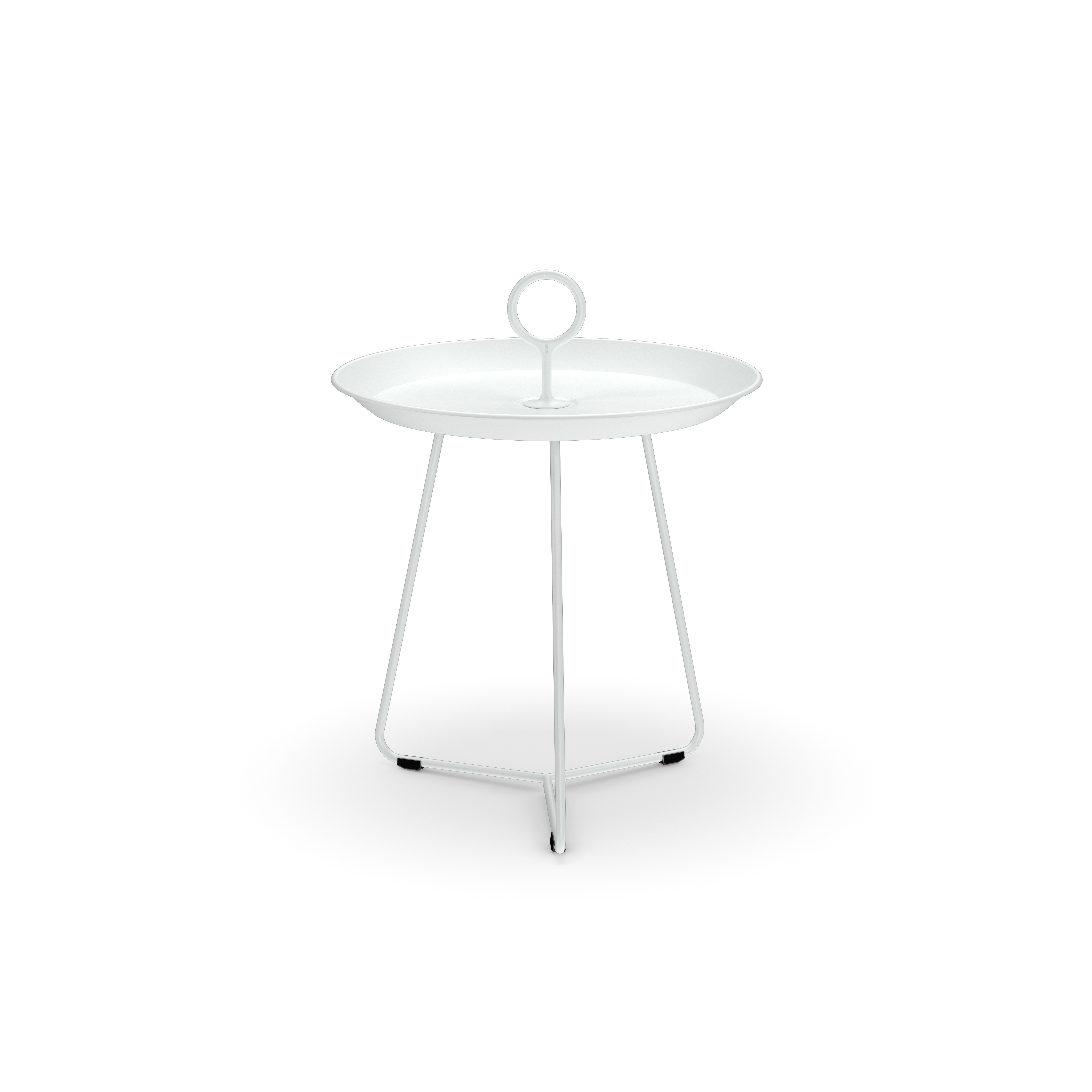 The Eyelet Tray Table by Houe is a small, white, round side table made from powder-coated steel. It has a circular handle on top and stands on three slender legs connected by a triangular base, set against a solid black background.