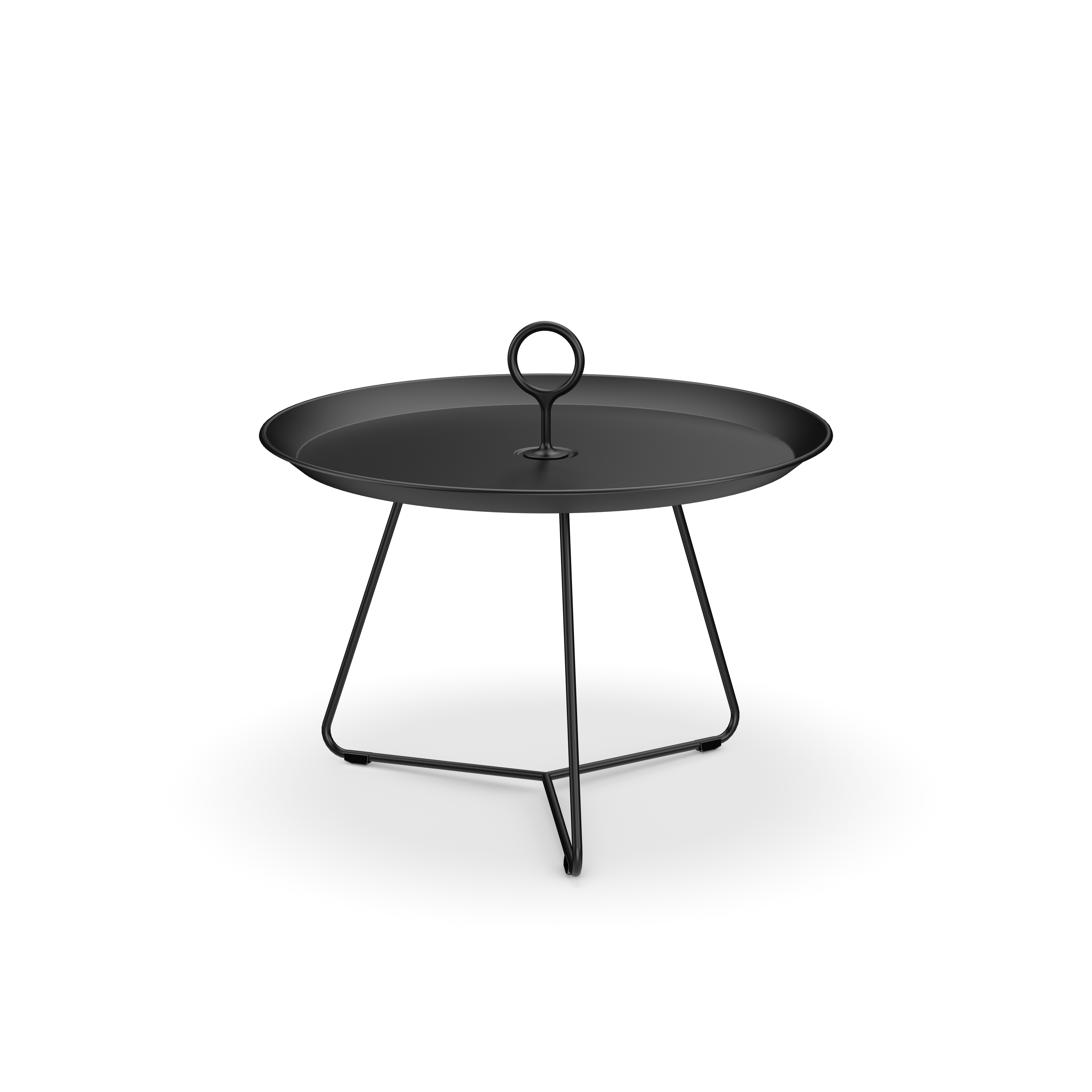 The Eyelet Tray Table by Houe is a round black metal side table with a raised edge and a central circular handle. Made from powder-coated steel, it stands on three angular legs forming a tripod base, showcasing a minimalist design that enhances its modern appeal.