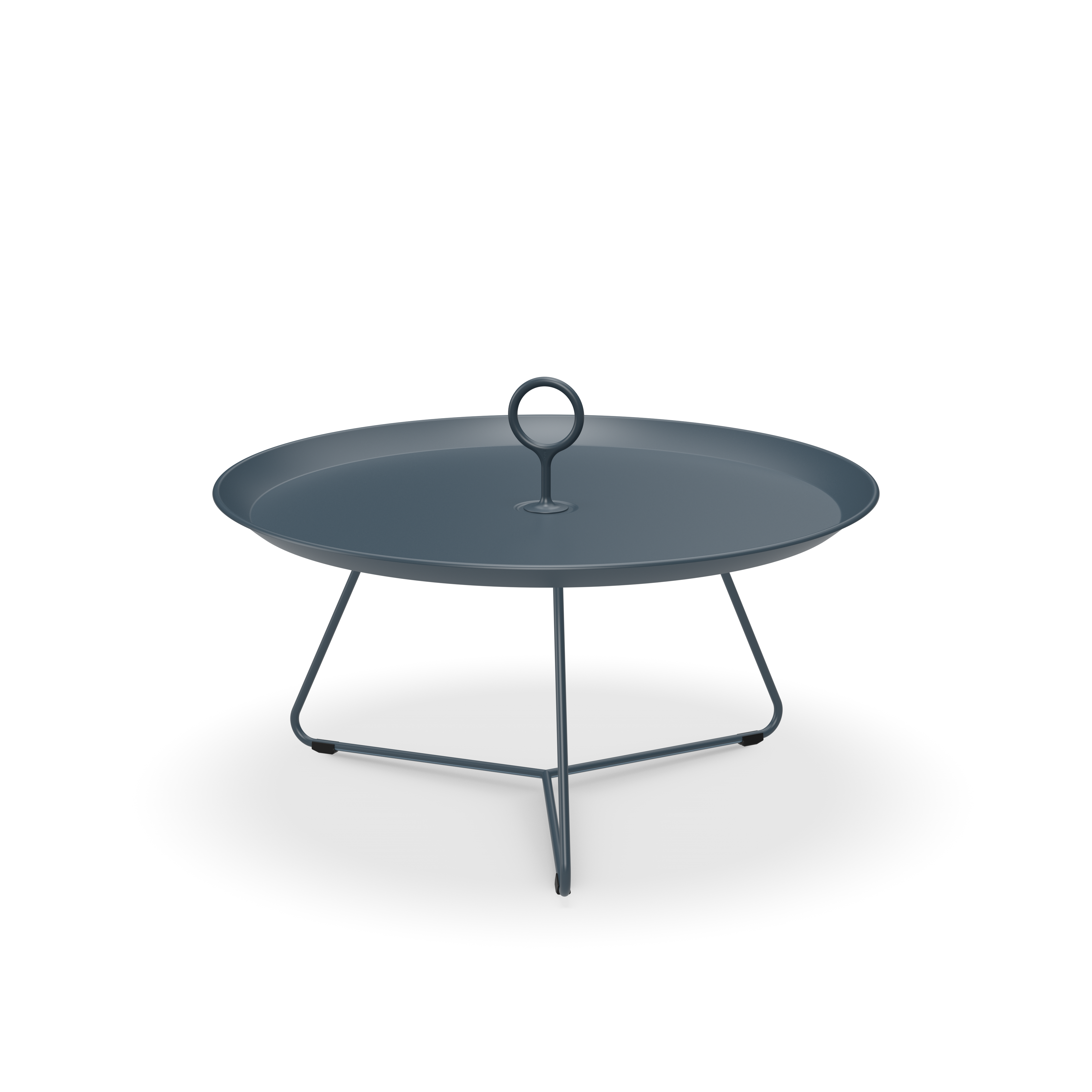 The Eyelet Tray Table by Houe is a modern, minimalist piece featuring a dark gray powder-coated steel tray with a central circular handle. It rests stylishly on a three-legged wire stand, serving dual purposes as both a serving tray and chic side table.