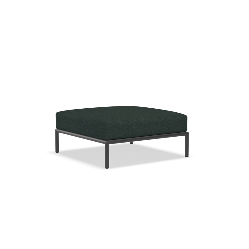 The Level Ottoman by Houe features a modern, minimalist design with a square shape. It has powder-coated aluminum legs and is upholstered in dark fabric.