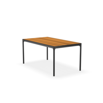The Houe Four Table features a rectangular design with a light brown wooden top and powder-coated black metal legs, making it an ideal addition to any outdoor dining collection. Set against a plain black background, this piece combines style and functionality.