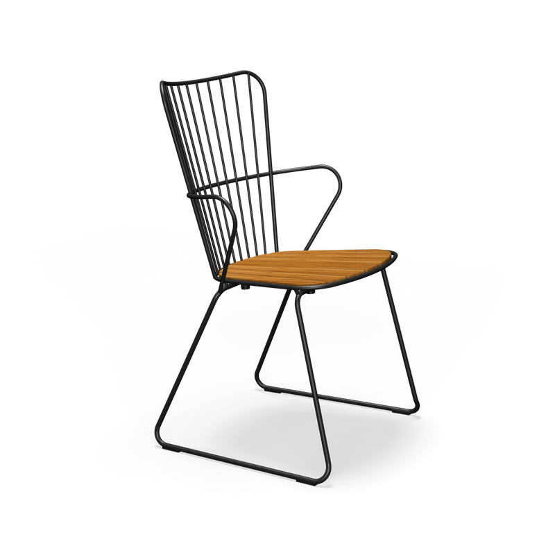 The Paon Dining Chair by Houe boasts a sleek black metal frame with a wooden seat, vertical back bars, and armrests. Inspired by Scandinavian design, its minimalist style features powder-coated steel construction that mirrors contemporary PAON chairs.