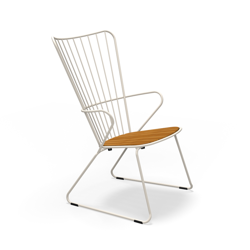 The Houe Paon Lounge Chair features a sleek design with a white powder-coated steel frame and wooden seat. Its back has vertical metal rods, and the legs form a continuous loop for a minimalist style.