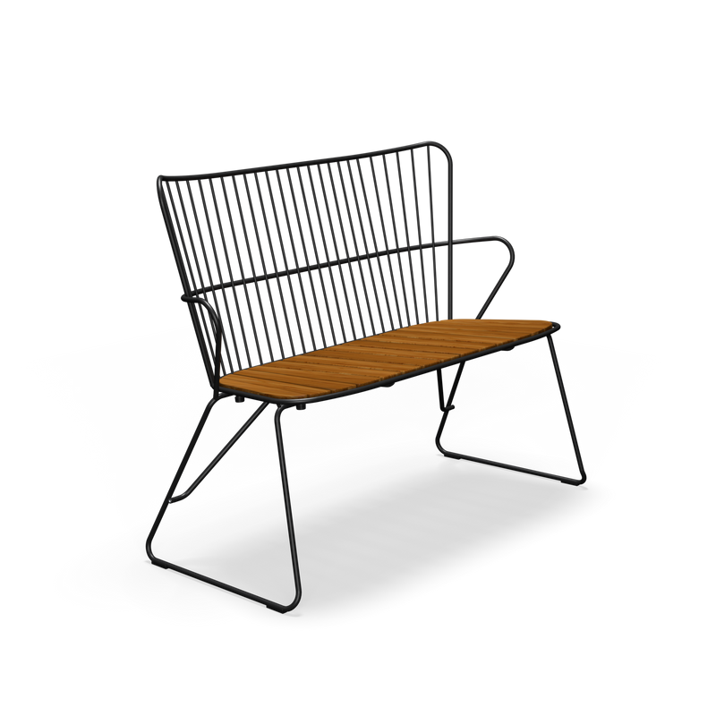 The Paon Bench by Houe features a sleek, minimalist modern design with a black metal frame and bamboo lamella wooden seat. Its thin vertical backrest rods and angled legs blend industrial style with Scandinavian design elements.