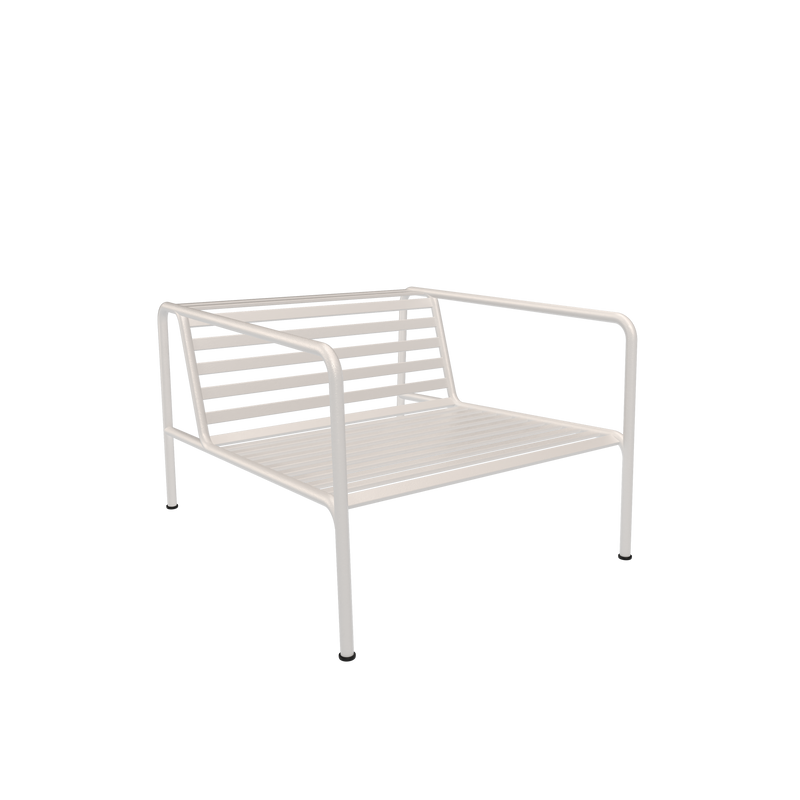 The Houe Avon Lounge Chair, in a minimalist design, features a white metal frame with slatted back and seat and armrests. The modern chair contrasts against a solid black background and includes UV protection for lasting durability.