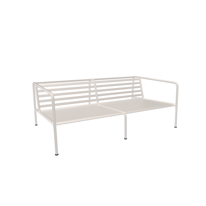 The Avon 2 Seater Sofa by Houe is a minimalist white metal piece with a slatted backrest and parallel armrests. Perfectly placed on a plain black background, it embodies modern design with weather-resistant durability and timeless style.