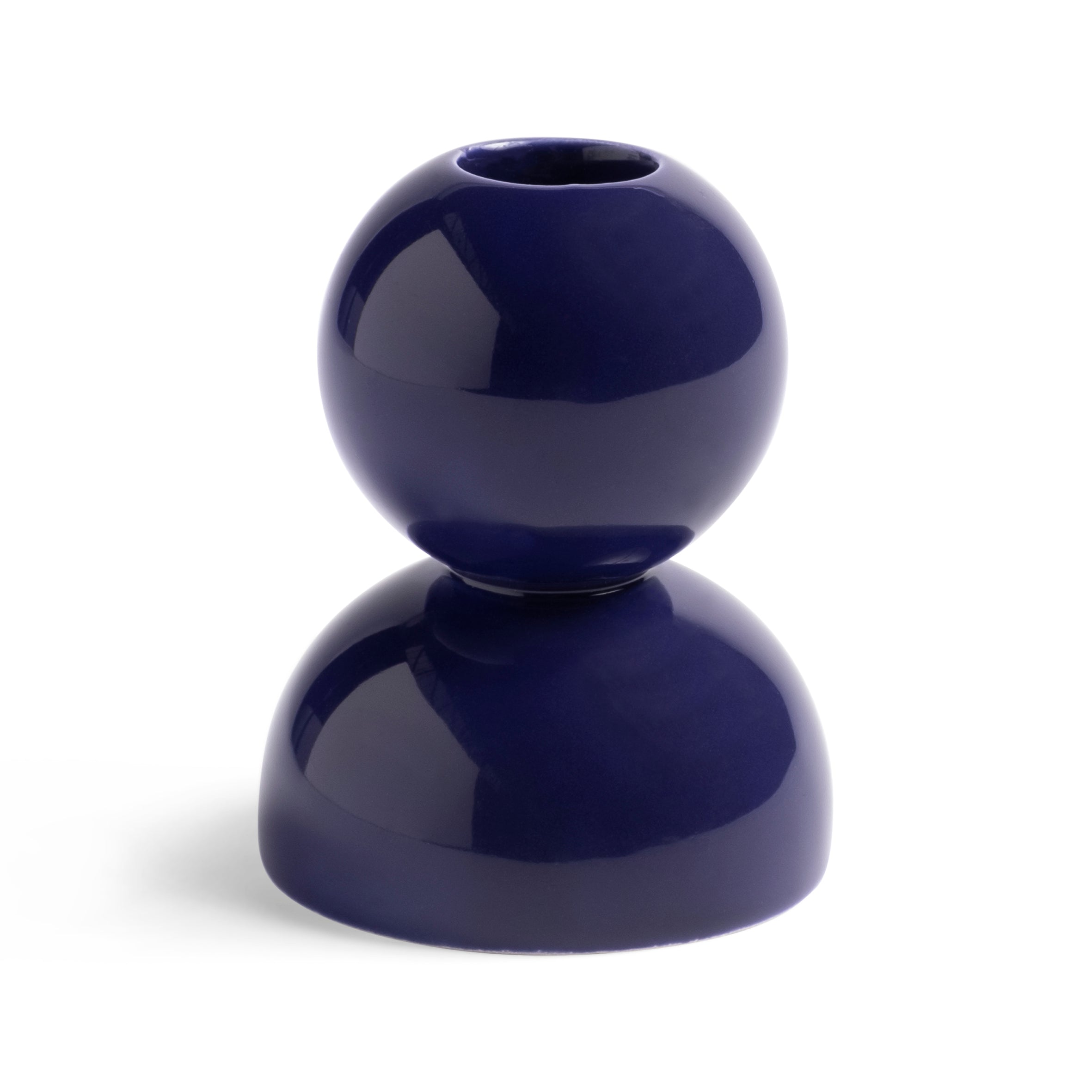 A glossy ceramic candlestick by &Klevering features a modern, spherical design in deep blue. The top is a complete circle with a candle opening, while the bottom is a half-sphere base. Its retro color pops beautifully against plain white backgrounds. Product: Candle Holder Stack Violet.