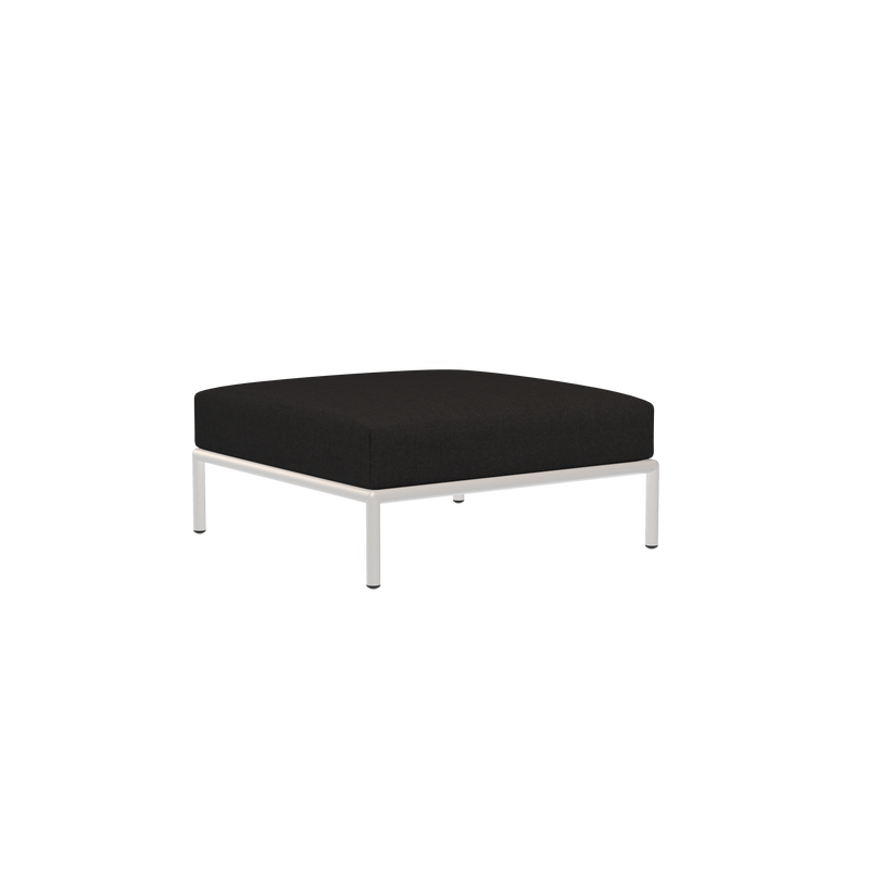 The Houe Level Ottoman features a minimalist design with a sleek silver metal frame and is crafted using water-repellent fabric. The ottoman has a square shape in black, set against a plain black background.