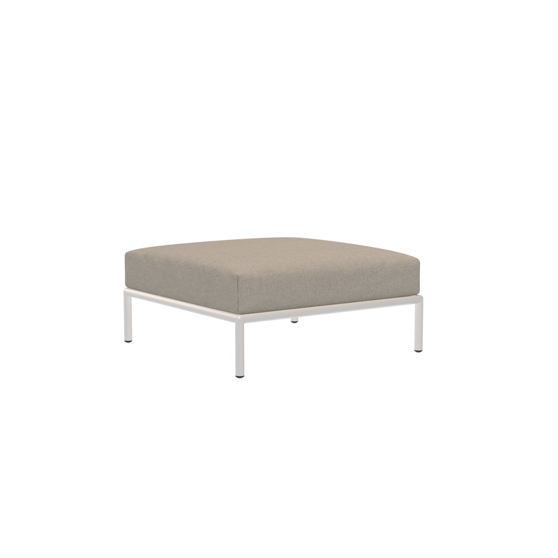 The Houe Level Ottoman features a modern design with a beige cushioned top crafted from water-repellent fabric and sleek white metal legs, presented against a solid black background.