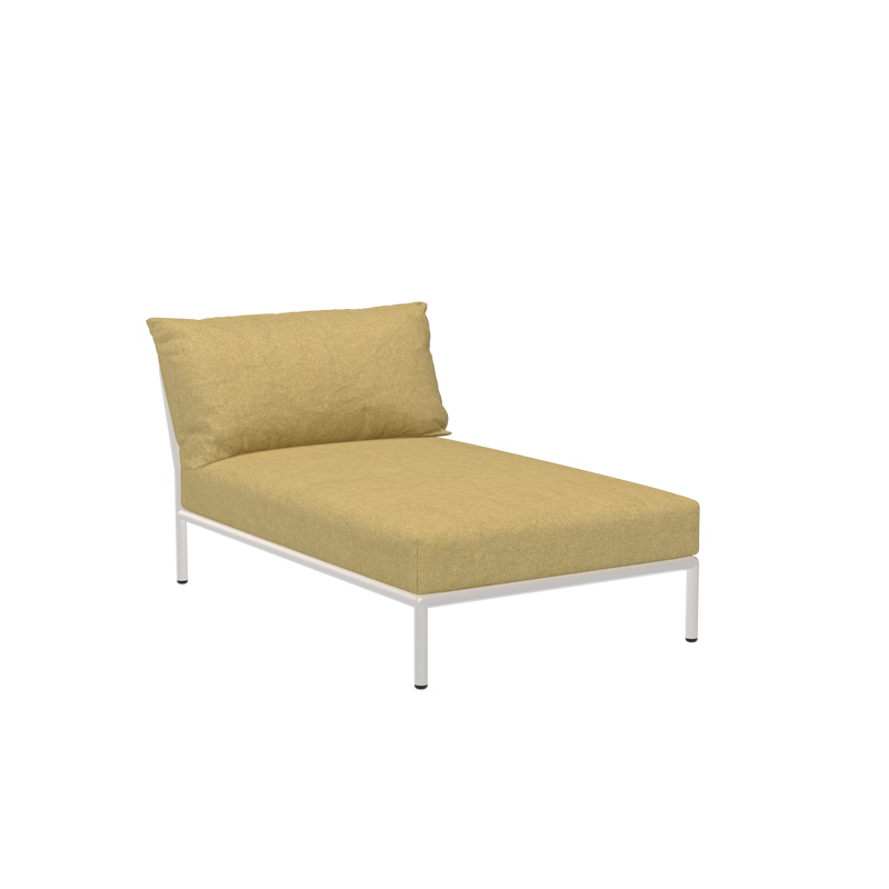 The Level Chaiselongue by Houe boasts a sleek white, powder-coated aluminum frame with a light yellow Sunbrella fabric cushion and pillow, set against a plain black background.