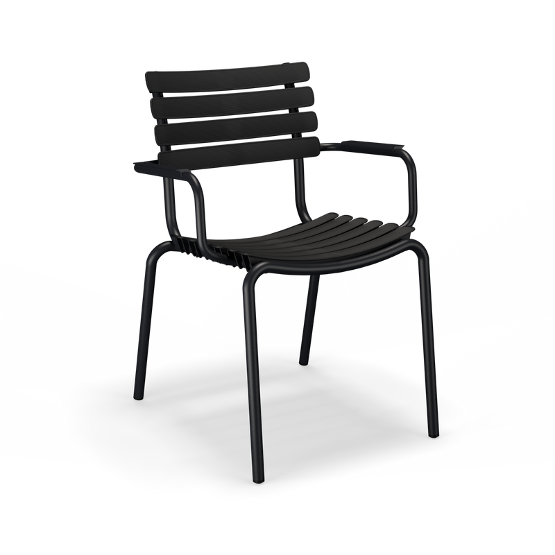 The ReClips Dining Chair by Houe has a slatted backrest and seat with armrests, embodying Danish design. Its modern, minimalist aesthetic is highlighted by four straight legs and a sleek black metal finish.