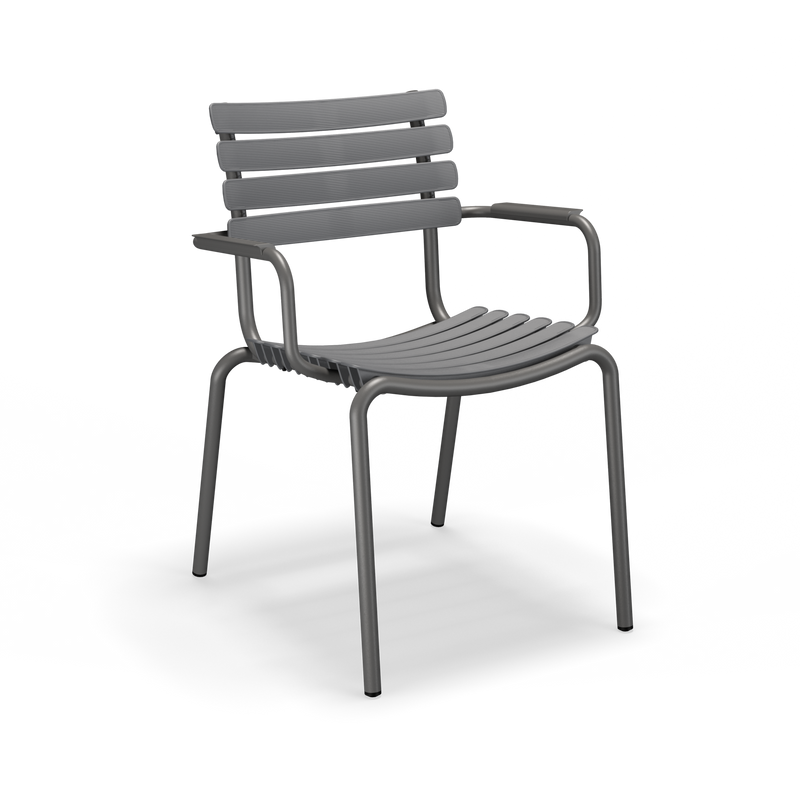 The Houe ReClips Dining Chair features a dark gray color with horizontal slats for the backrest and seat, armrests, and four straight legs. Its minimalist Danish design is highlighted against a solid black background, showcasing an eco-friendly approach inspired by plastic recycling.