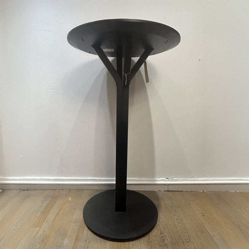Bloom Bar Table Round - Sale black round table with a unique four-legged pedestal frame on wooden floor.