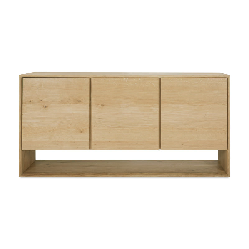 The Ethnicraft Nordic Sideboard features a modern light wood design with beveled edges, three flat doors, and a lower open shelf, shown against a white background.