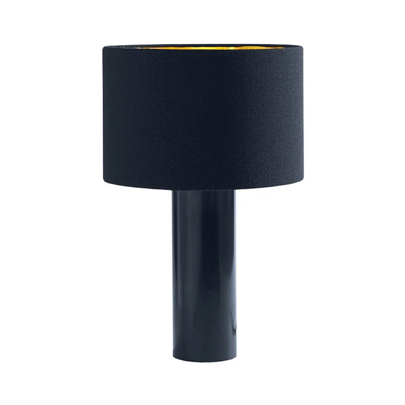 The ALL ROUND Table Lamp by Victor Foxtrot is a modern piece with a black powder-coated steel cylindrical base and a wide round wool fabric shade. Its gold interior provides a striking contrast to the sleek design.