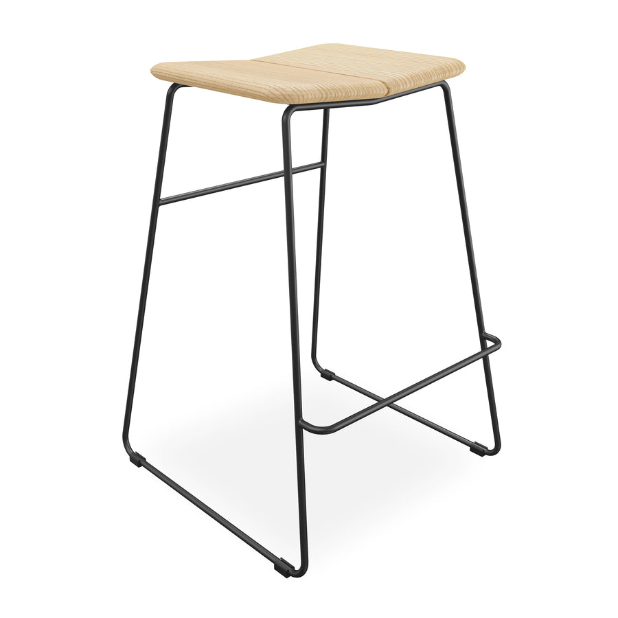 The Gus Modern Aero Bar Stool features Scandinavian design with a curved solid ash wood seat, sleek black metal legs, and an integrated footrest for a modern touch.