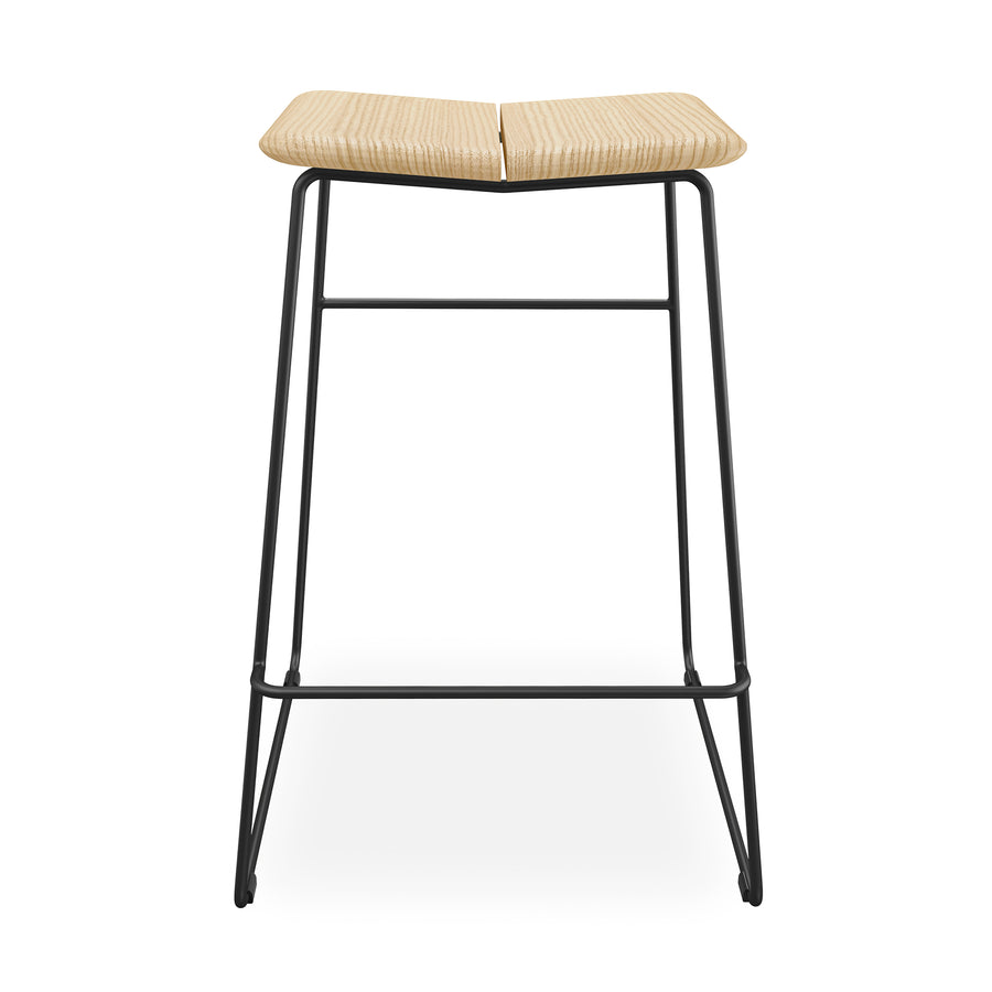 The Gus Modern Aero Bar Stool showcases Scandinavian design with a contoured solid Ash wood seat and a sleek black metal frame, viewed from the front against a white background.