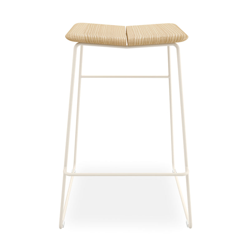 The Gus Modern Aero Bar Stool showcases a contoured solid Ash wood seat and a white metal frame with footrest, combining minimalist contemporary style with Scandinavian design.