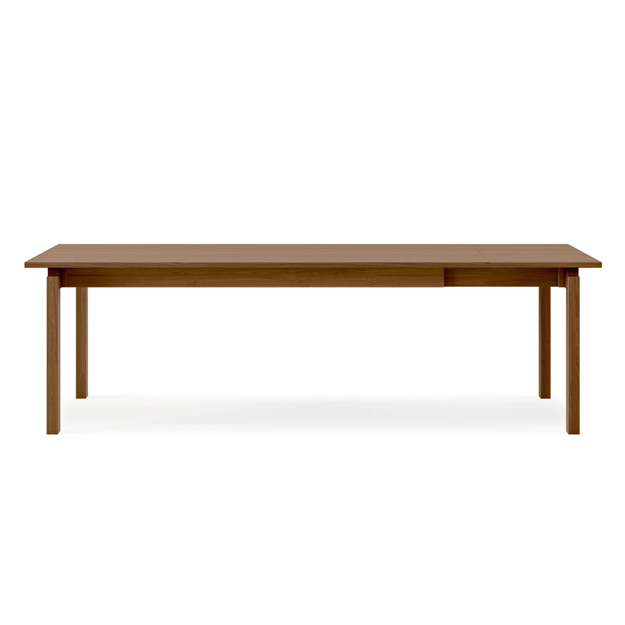 The Gus Modern Annex Extendable Dining Table features a rectangular wooden top with four straight legs, displayed against a plain white background.