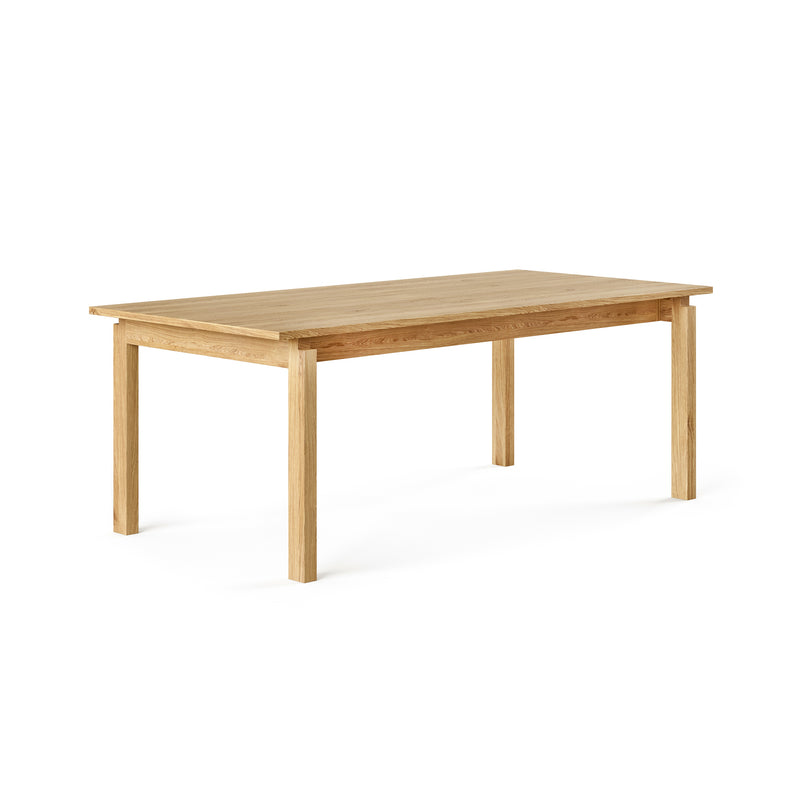 The Annex Extendable Dining Table by Gus Modern features a rectangular shape, four straight legs, and a smooth natural wood finish—an ideal and stylish dining table for any space, shown here against a plain white background.